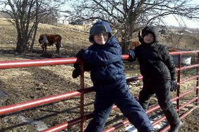 Jake and Luke Prater on cattle gate