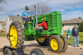 Mike riding the John Deere A repowered tractor with an IH 345 motor