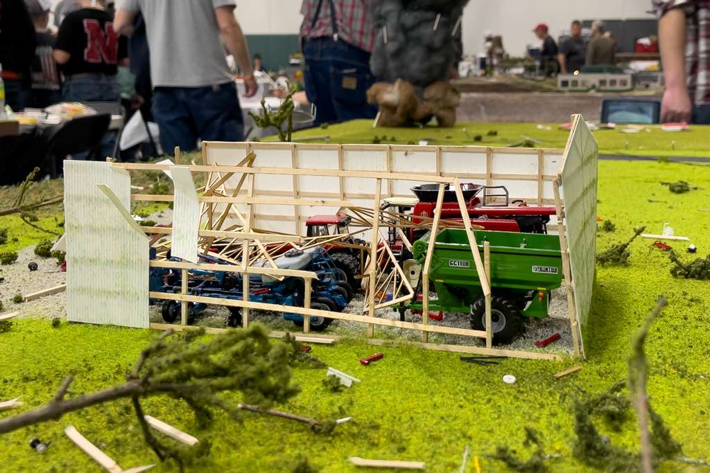 A model machine shed with the roof torn off from the tornado.