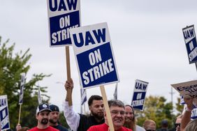 UAW members hold strike signs outside John Deere