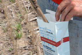 a farmer takes a soil sample