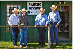 Four men outside Rancho Mission Viejo building