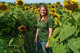 Mikayla Tabert standing in sunflowers