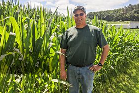 Portrait of Myron Sylling in front of his corn