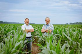 Travis Senter and his father standing in their field