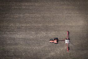 A tractor and planter in a field