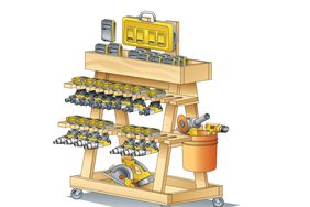 An illustration of a tool cart made of wood. There are drills hanging in two rows on the front, with an open box on top for drill bits and batteries. There is storage below and an orange bucket attached to the side for additional storage.