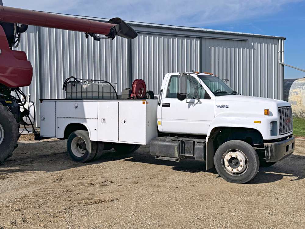 white service truck parked on gravel