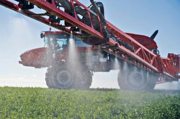 Red sprayer in field