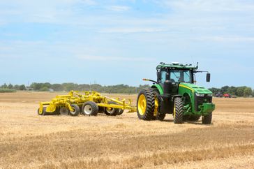 AGCO's OutRun autonomous system on a John Deere 8R tractor pulling a tillage implement.