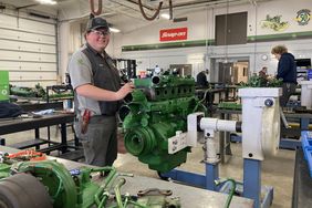 A student works on an engine at the John Deere Tech Program