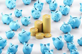 Stacks of Dollar coins placed among of piggy banks arranged to rows