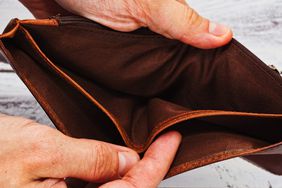 A farmer holding an empty wallet.