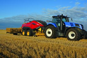 red New Holland BigBaler 340 High Density with a blue New Holland tractor