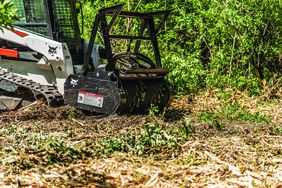 The new drum loader attachment on a Bobcat skid loader.