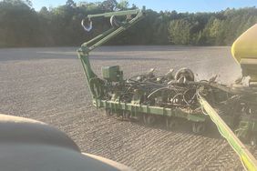 A dusty green planter at work in a Maryland field