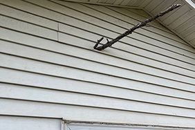 stick stuck in side of Jerry Nelson's house