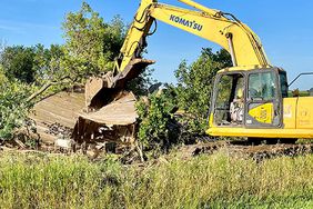 Dustin Nelson tearing down old hog barn