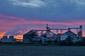 An ethanol plant with the sunset in the background.