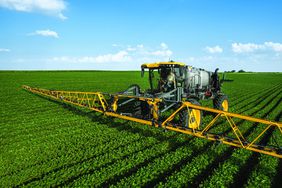 A model year Hagie sprayer in a field of soybeans