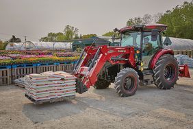 The Farmall 75C Electric tractor in a flower nursery.