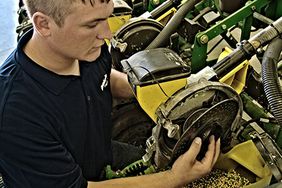 Farmer working on a seed meter.