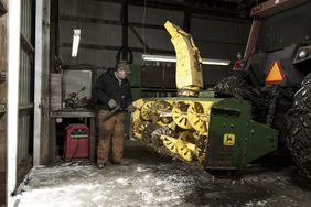 A farmer working in his shop during winter.