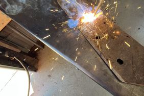 The author strikes the first arc with his vintage electric welder in his refurbished farm shop.