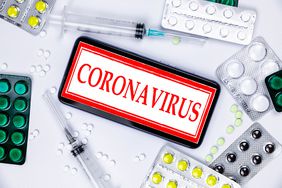 Coronavirus surrounded by needles and pills