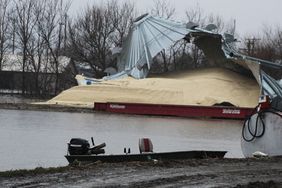 Grain spills out of a flood ravaged grain bin in Iowa