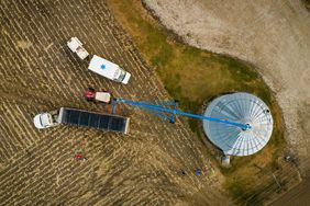 An Iowa farmer fills a grain bin at harvest