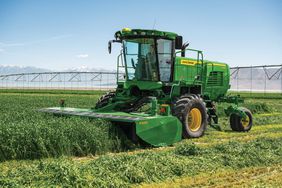 John Deere W200 series windrower in the field.