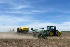 South Dakota farmer Lee Lubbers plants his crop on a sunny day with a John Deere tractor and planter