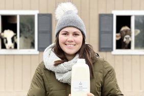 Mikayla Fasone holds a half-gallon of her farm's raw milk