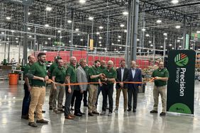 Company leadership cuts the ribbon at Precision Planting's Morton, IL facility.