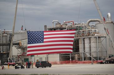 A flag is displayed in front of Southwest Iowa Renewable Energy