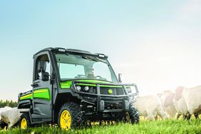 A John Deere Gator in a field.