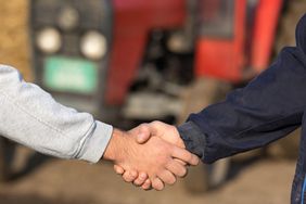 Two farmers shaking hands.