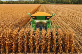 John Deere combine harvesting corn