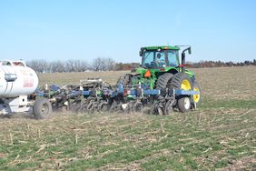 A John Deere tractor applies anhydrous ammonia.