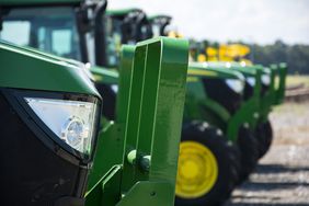 John Deere tractors lined up at an auction.