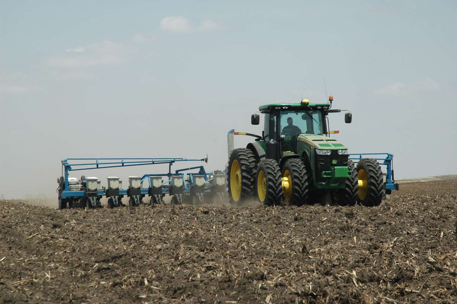 A John Deere tractor with a Kinze planter.