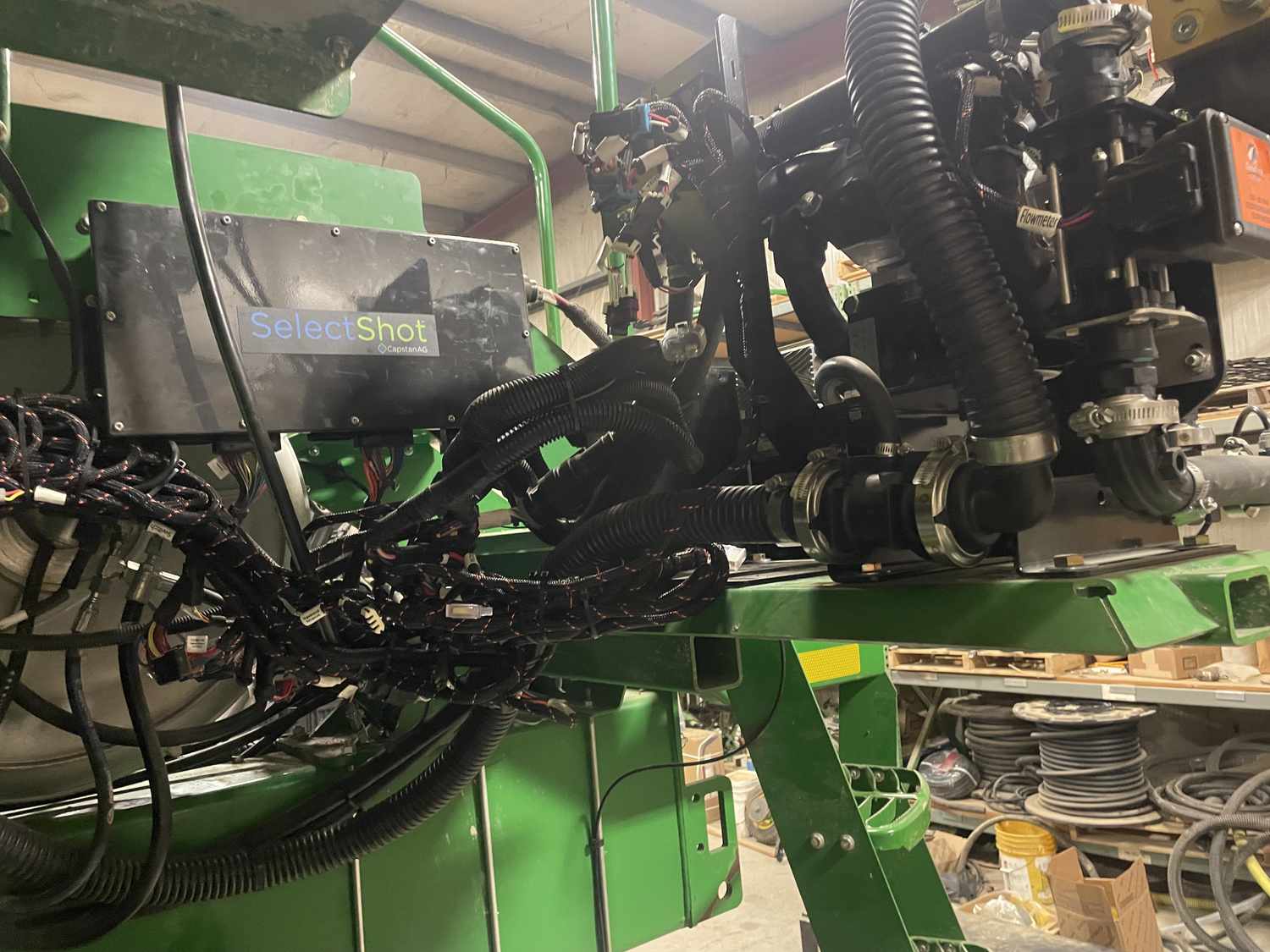 A John Deere planter equipped with Select Shot sits in the farm shop on Kelly Garrett's Iowa farm