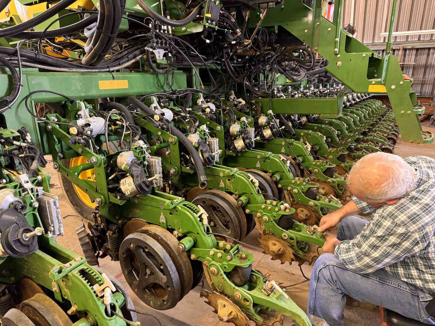 North Carolina farmer Kevin Matthews works on his John Deere planter in the farm shop