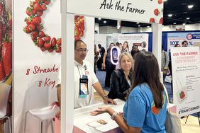 Heather Lifsey talking to strawberry farmers at a conference.