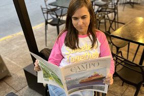 Heather Lifsey reading El Campo newspaper in Chile