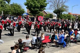 Marching band students wear red band uniforms