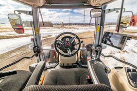 The interior cab of a Massey Ferguson 6S tractor.