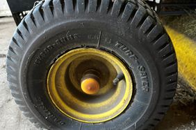 A black flat rear tire on a lawn mower