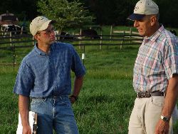 two men standing in pasture